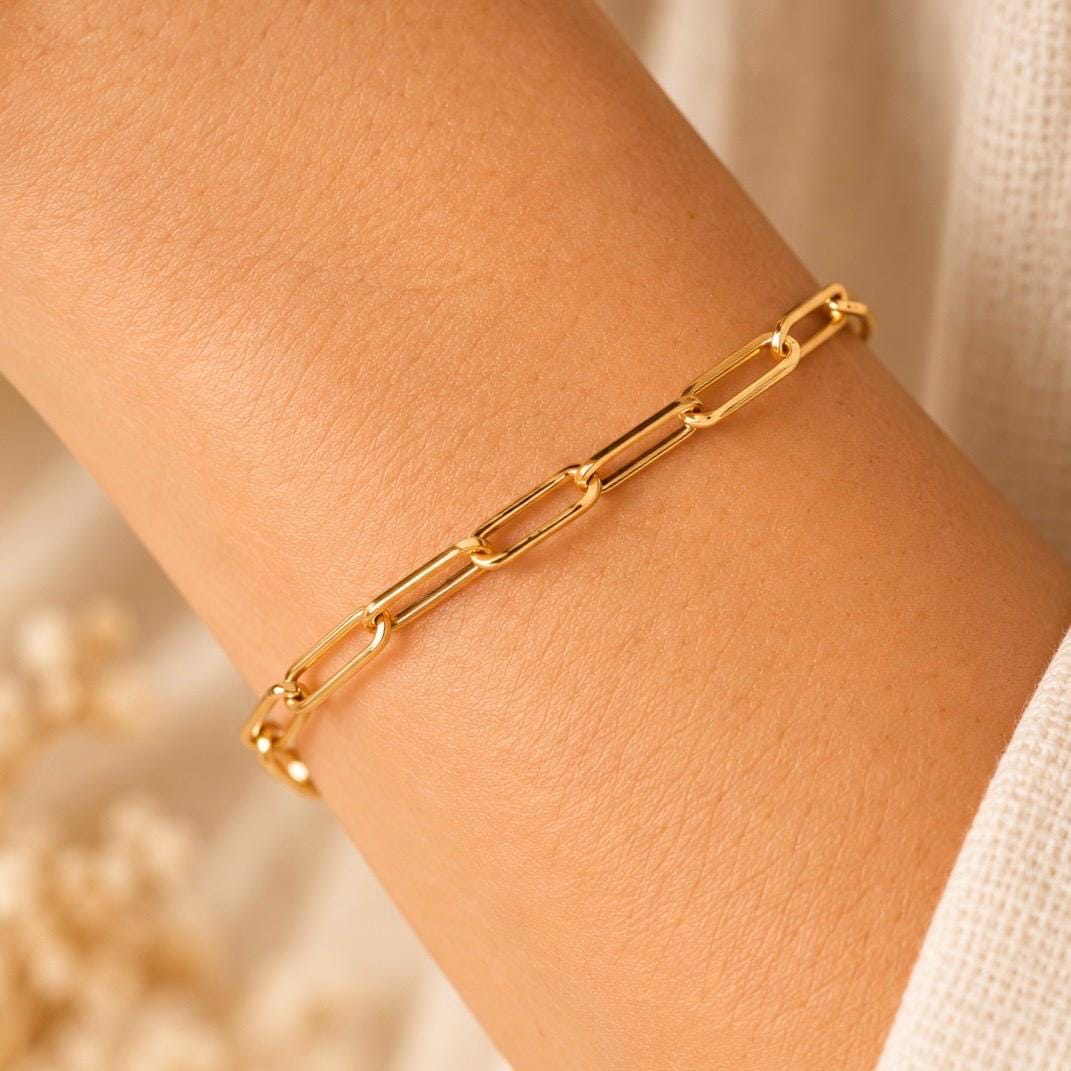 Close-up of 14K gold plated elongated paperclip link bracelet on wrist