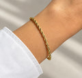 14K gold plated twisted rope chain bracelet worn on wrist, close-up