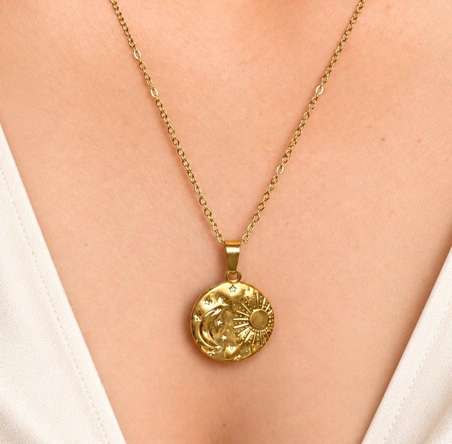 Gold celestial sun moon and stars medallion pendant necklace worn around the neck