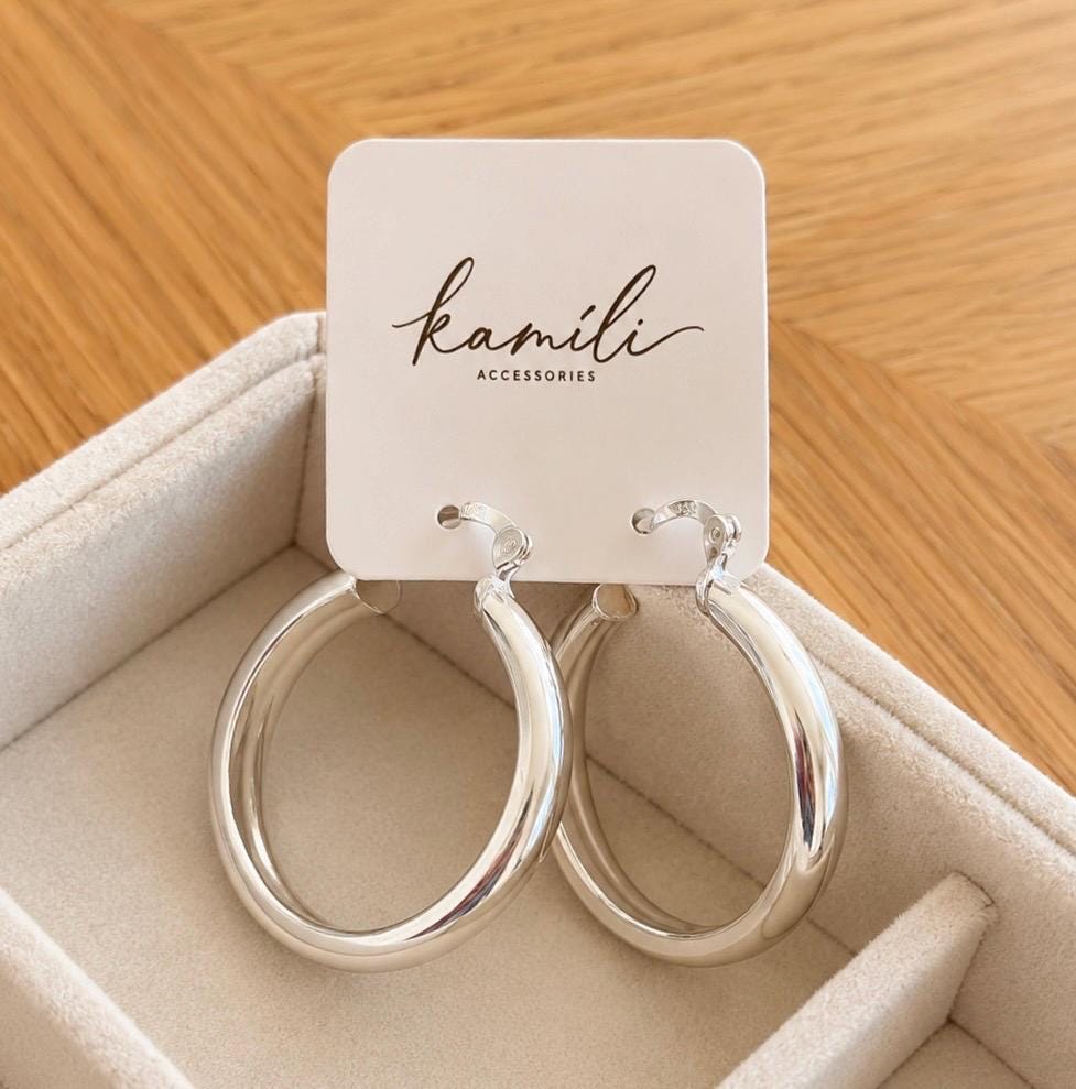 Pair of 35mm sterling silver hoop earrings displayed on Kamíli Accessories branded jewellery card