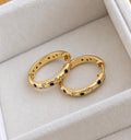 Gold-plated sterling silver celestial blue star and crescent moon CZ hoop earrings on velvet