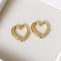Pair of gold plated 925 sterling silver open heart hoop earrings on a cream jewellery tray