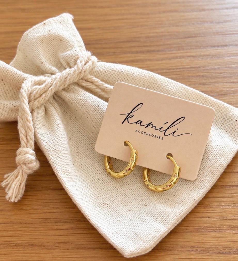 Kamíli Accessories gold star engraved hoop earrings on branded card and cotton gift pouch
