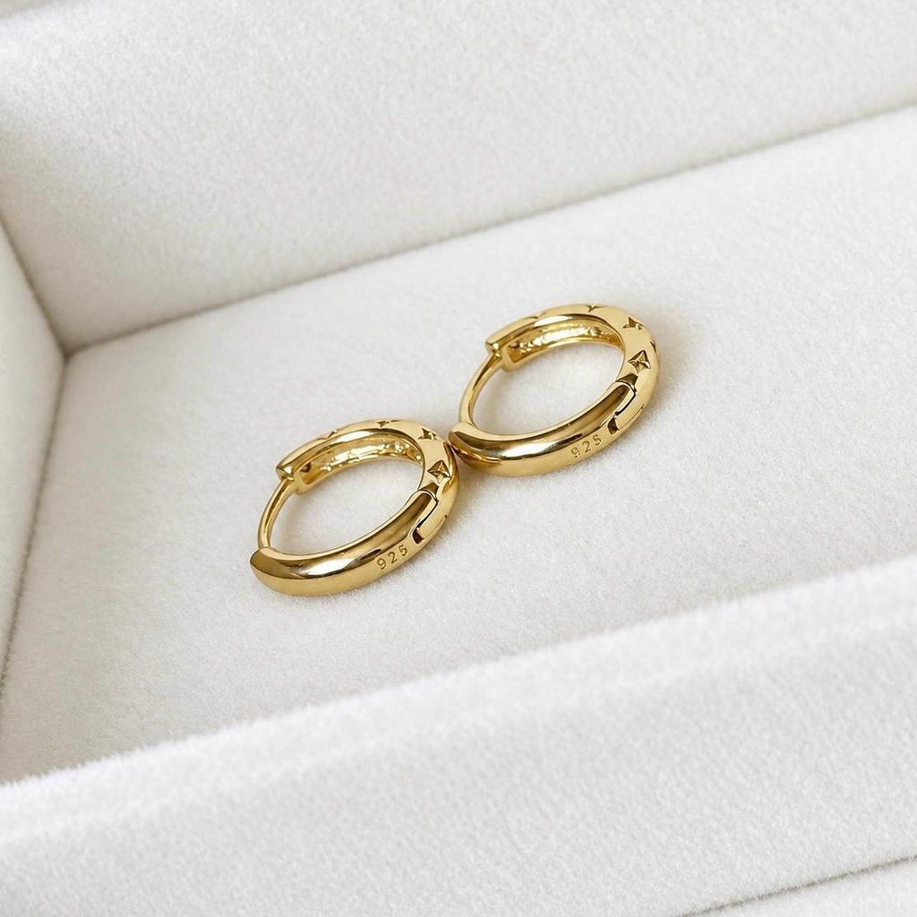 Back view of gold plated sterling silver huggie hoops showing 925 markings
