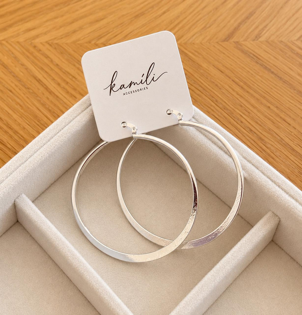 55mm sterling silver hoop earrings on Kamíli Accessories card on cream jewellery tray