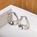 925 sterling silver sculptural twisted teardrop hoop earrings in white velvet jewellery box