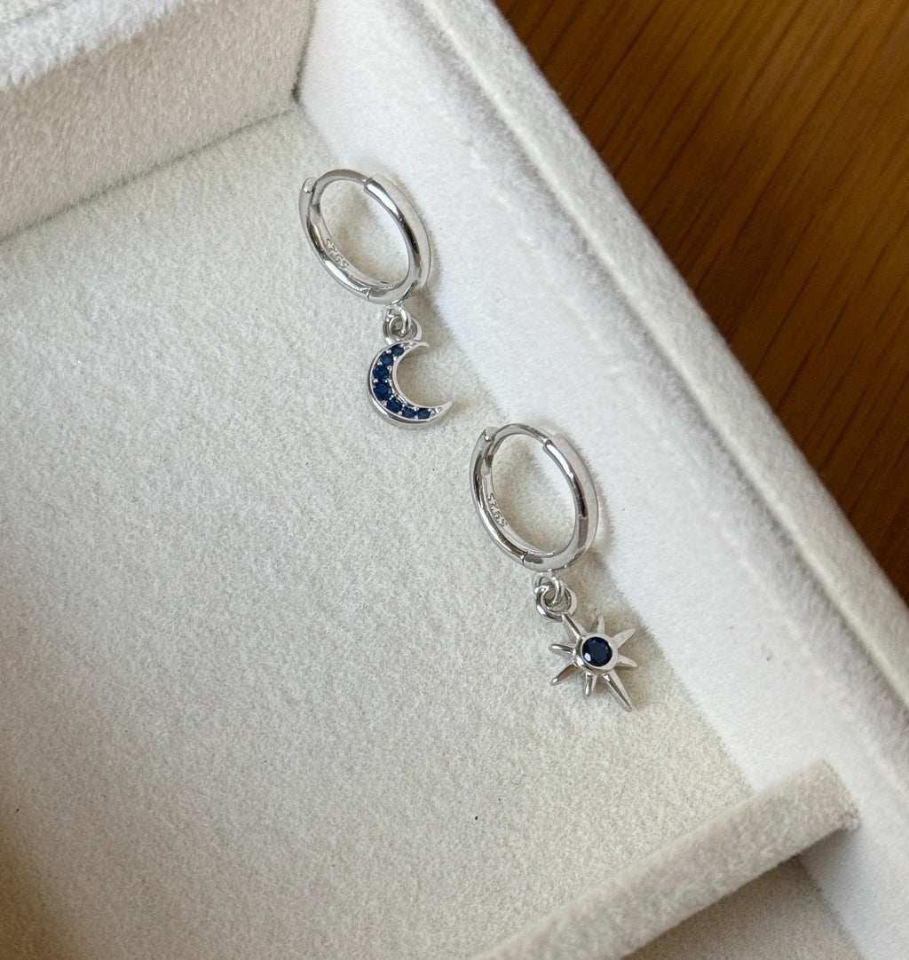 Sterling silver moon and star hoops with blue stones, showing 925 marking