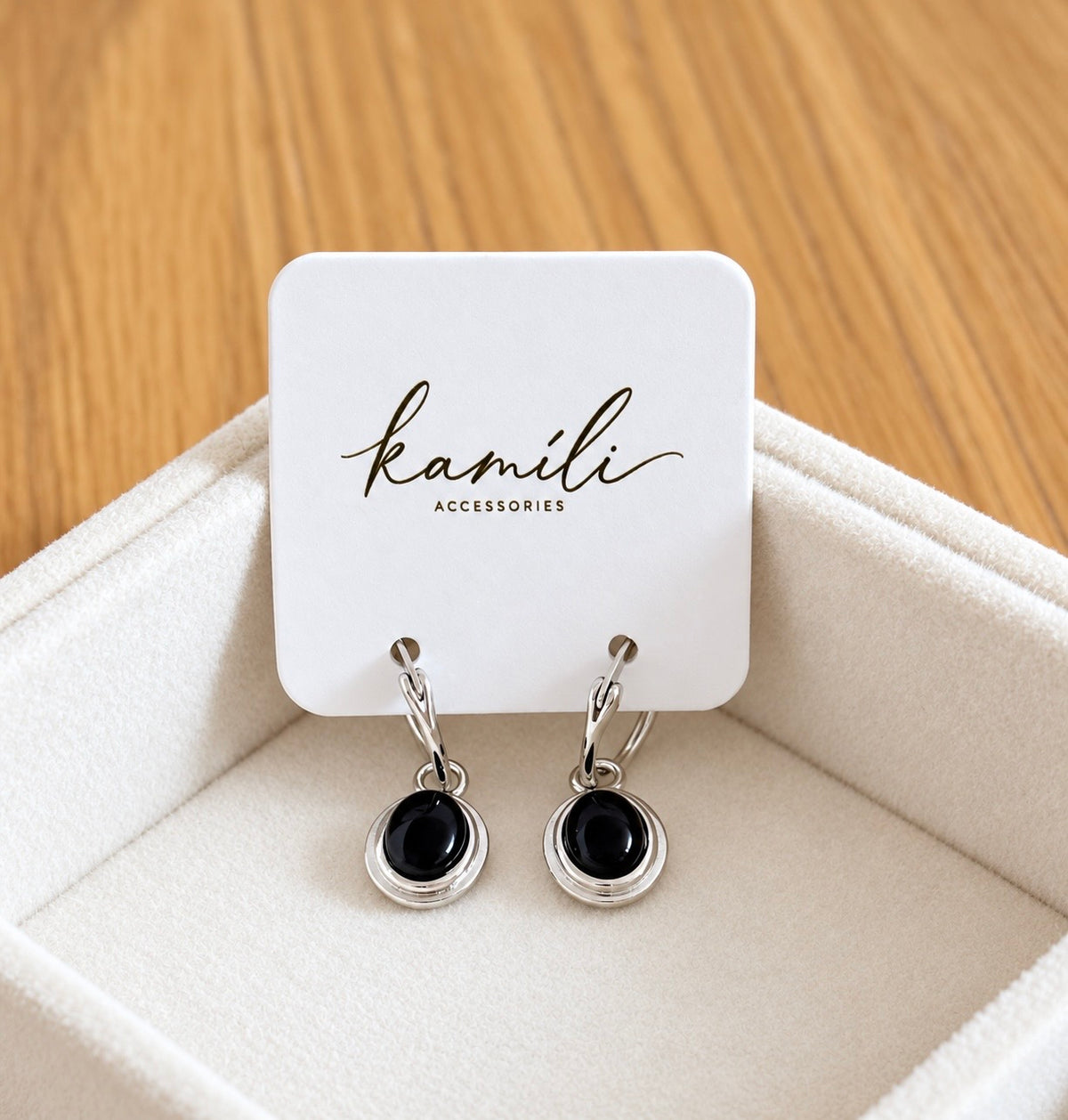 Black agate hoop earrings displayed on Kamíli Accessories branded card