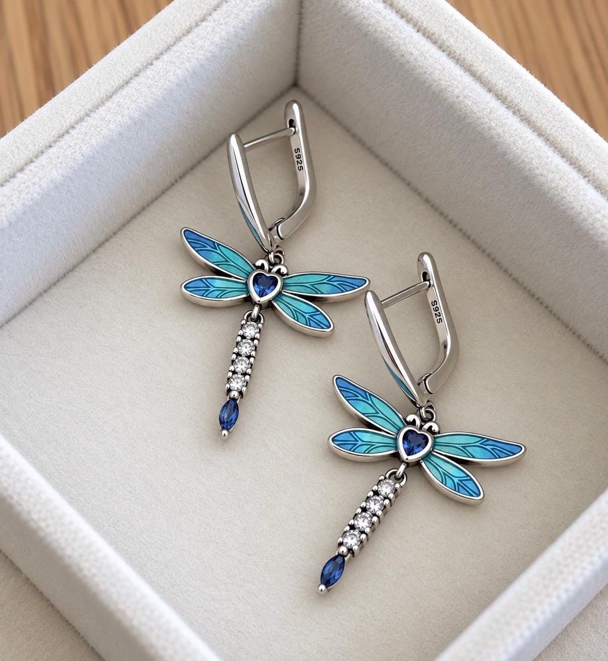 Close-up of sterling silver S925 leverback dragonfly earrings with blue turquoise enamel wings