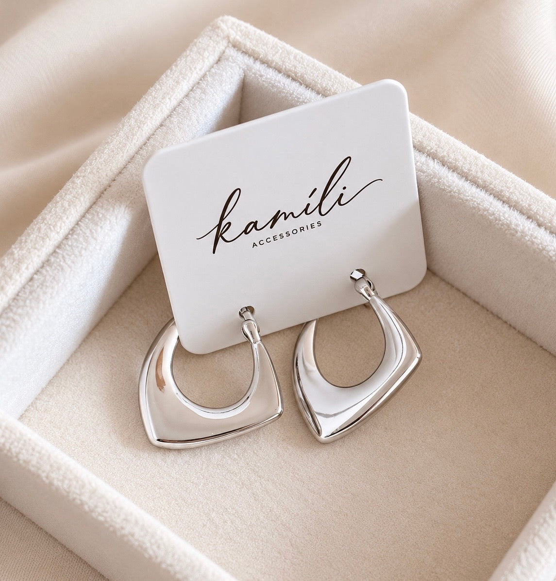 Silver geometric hoop earrings displayed on Kamili Accessories jewellery card