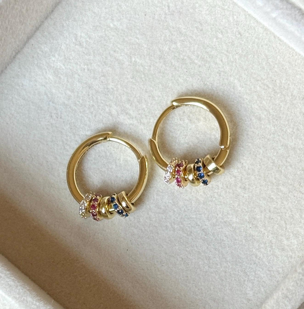 Pair of gold hoop earrings showing pink blue and clear coloured stone bead details