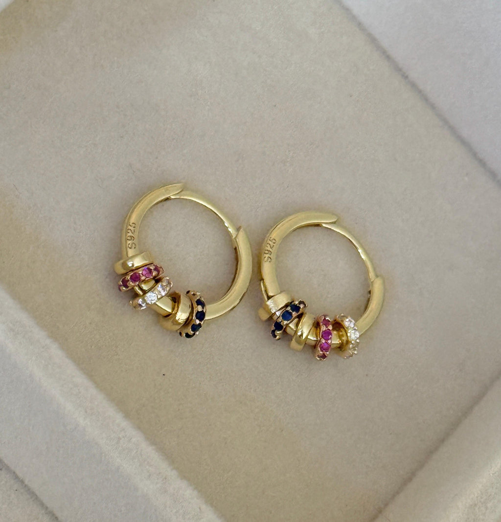 Close-up of gold beaded hoop earrings showing S925 sterling silver stamp