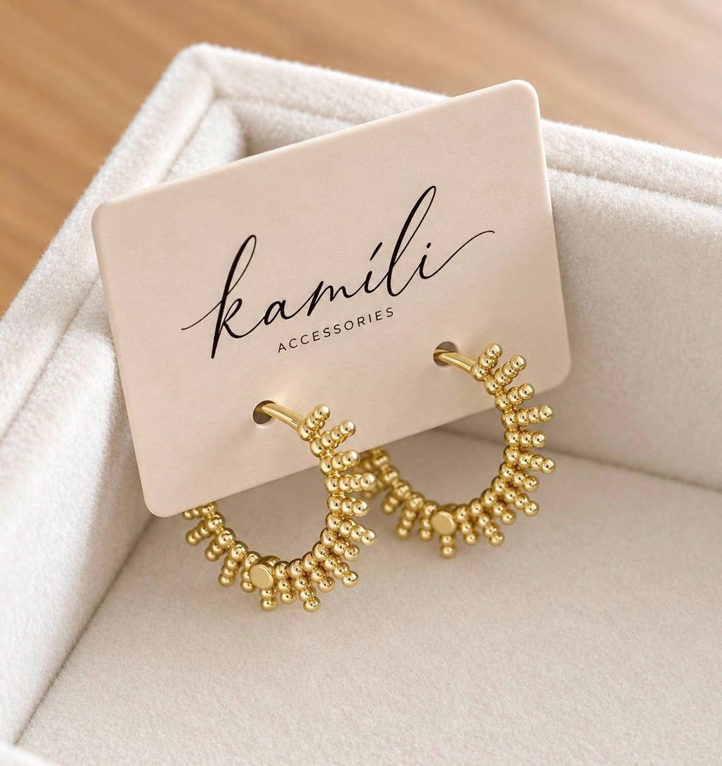 Gold plated beaded sunburst hoop earrings displayed on Kamíli Accessories branded jewellery card