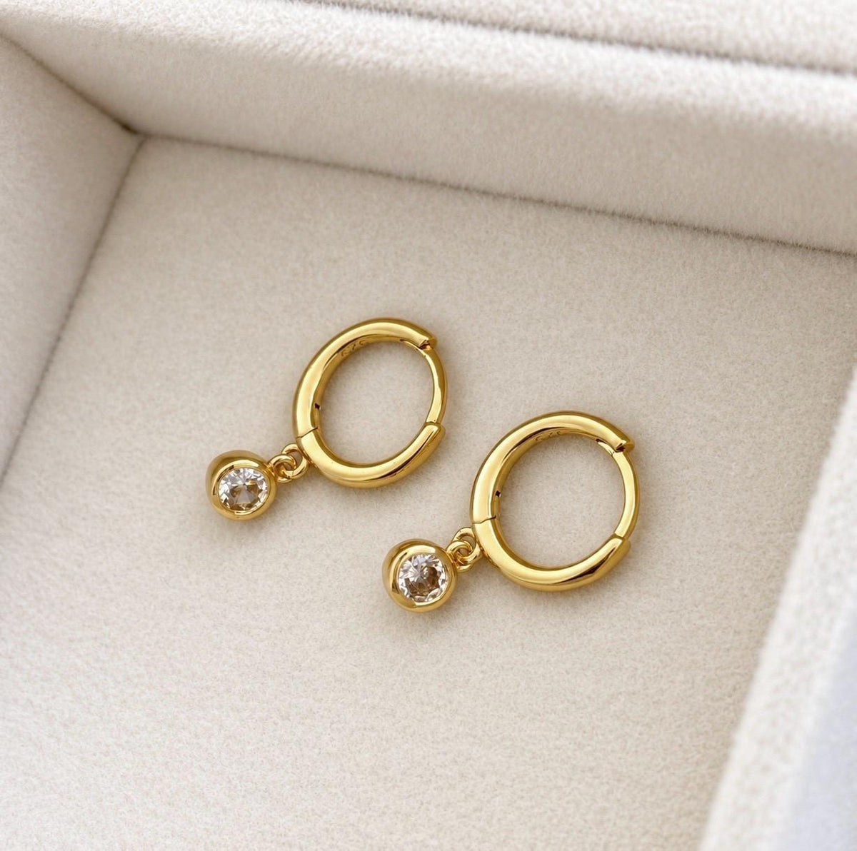 Gold colour hinged huggie hoop earrings with clear CZ stone dangles