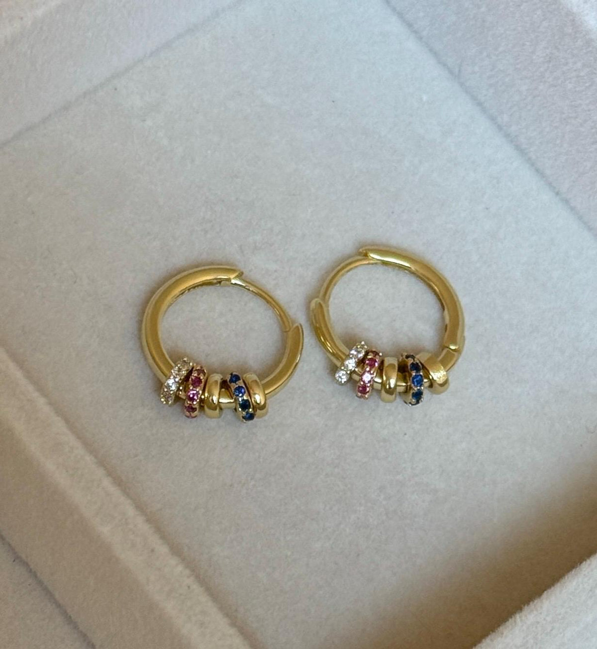 Front view of 925 sterling silver gold plated hoop earrings with multicoloured CZ beads