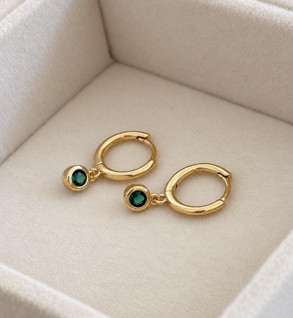 Gold colour sterling silver huggie hoop earrings with green CZ drop stones