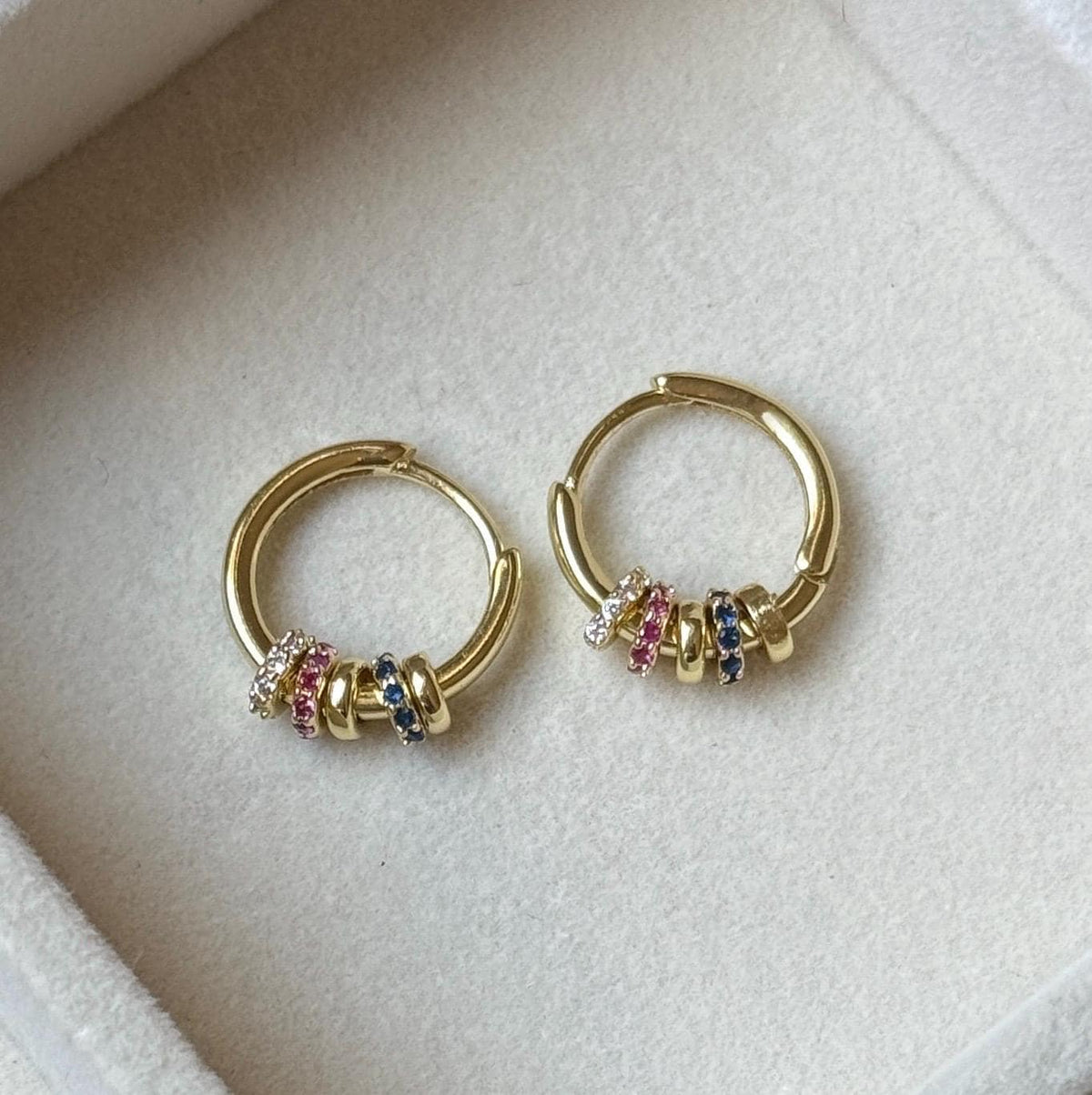 Gold hoop earrings with delicate pink blue and clear cubic zirconia beaded accents