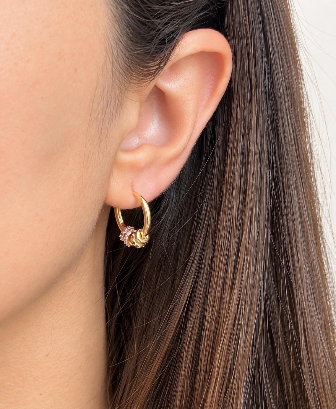 Gold plated multicolour CZ beaded hoop earring worn on the ear