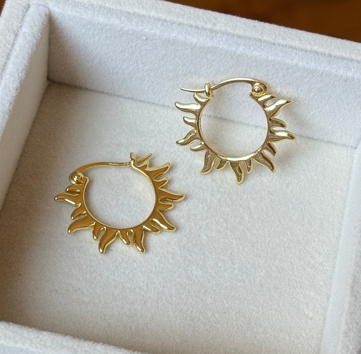 Reverse view of gold plated sun hoop earrings showing hinged fastening