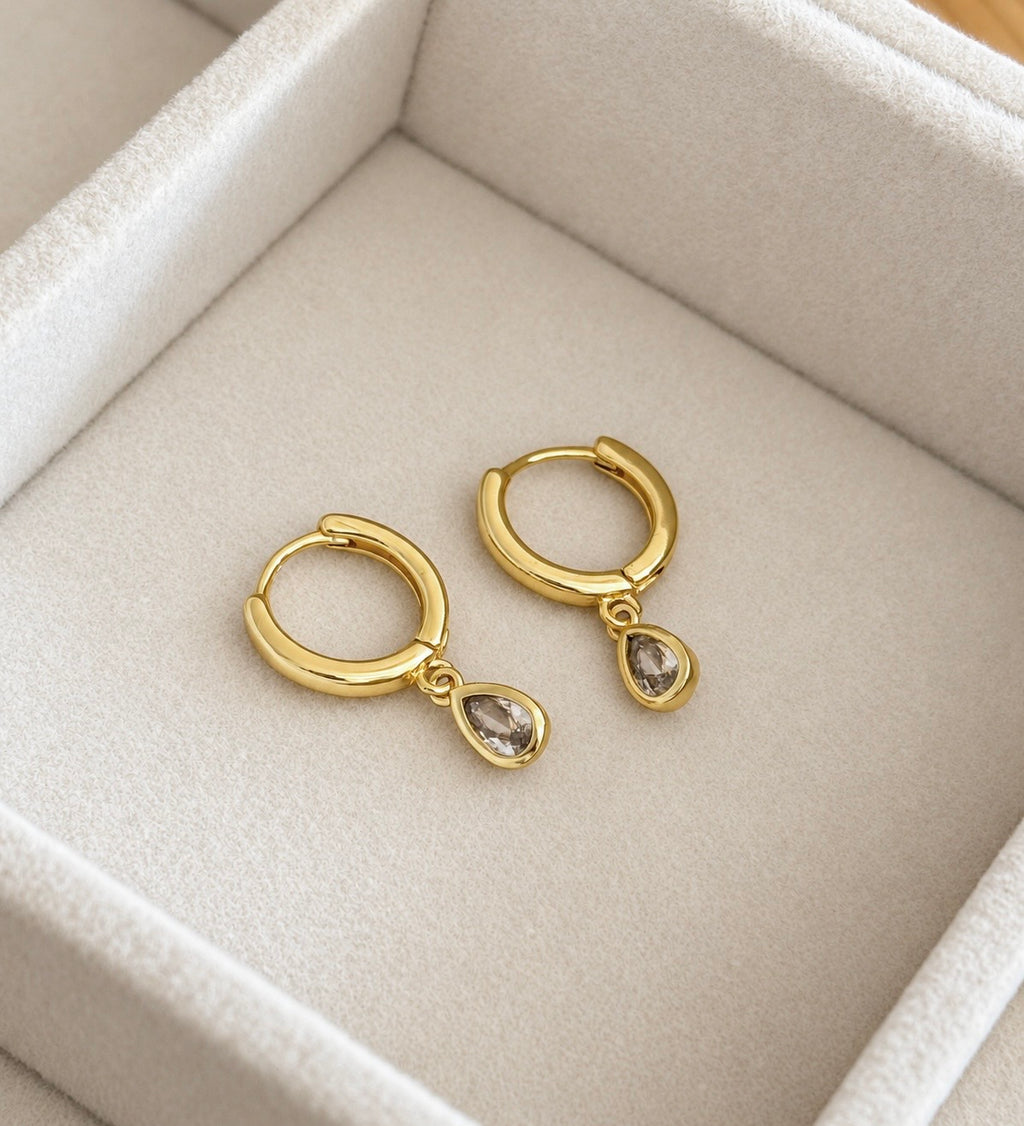 Front view of pair of gold plated sterling silver teardrop CZ hoop earrings