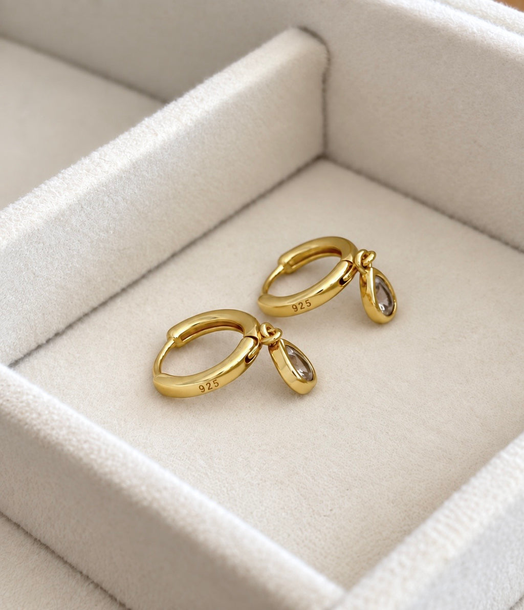 Back of earrings with 925 stamp visible on gold-plated silver hoops