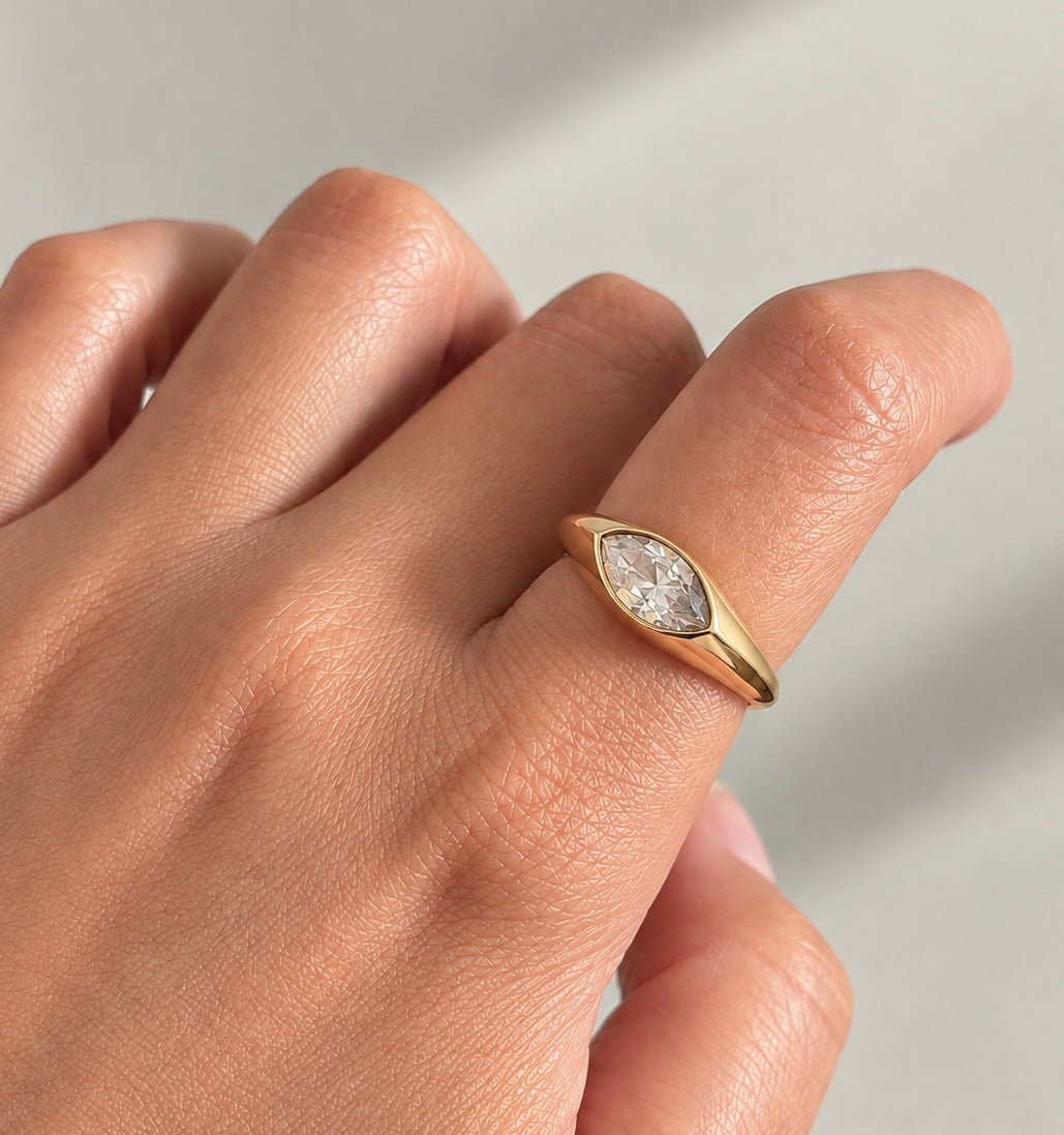 Gold-plated marquise ring with clear transparent stone worn on finger