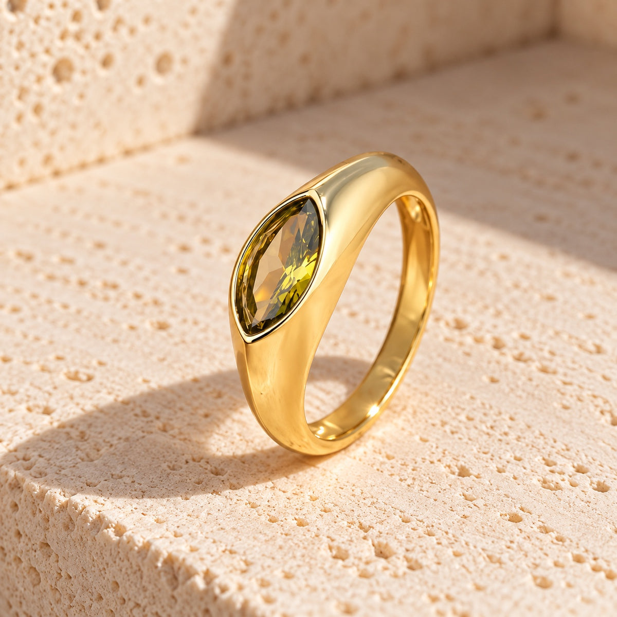 Olive green marquise cubic zirconia ring with polished gold-plated silver band