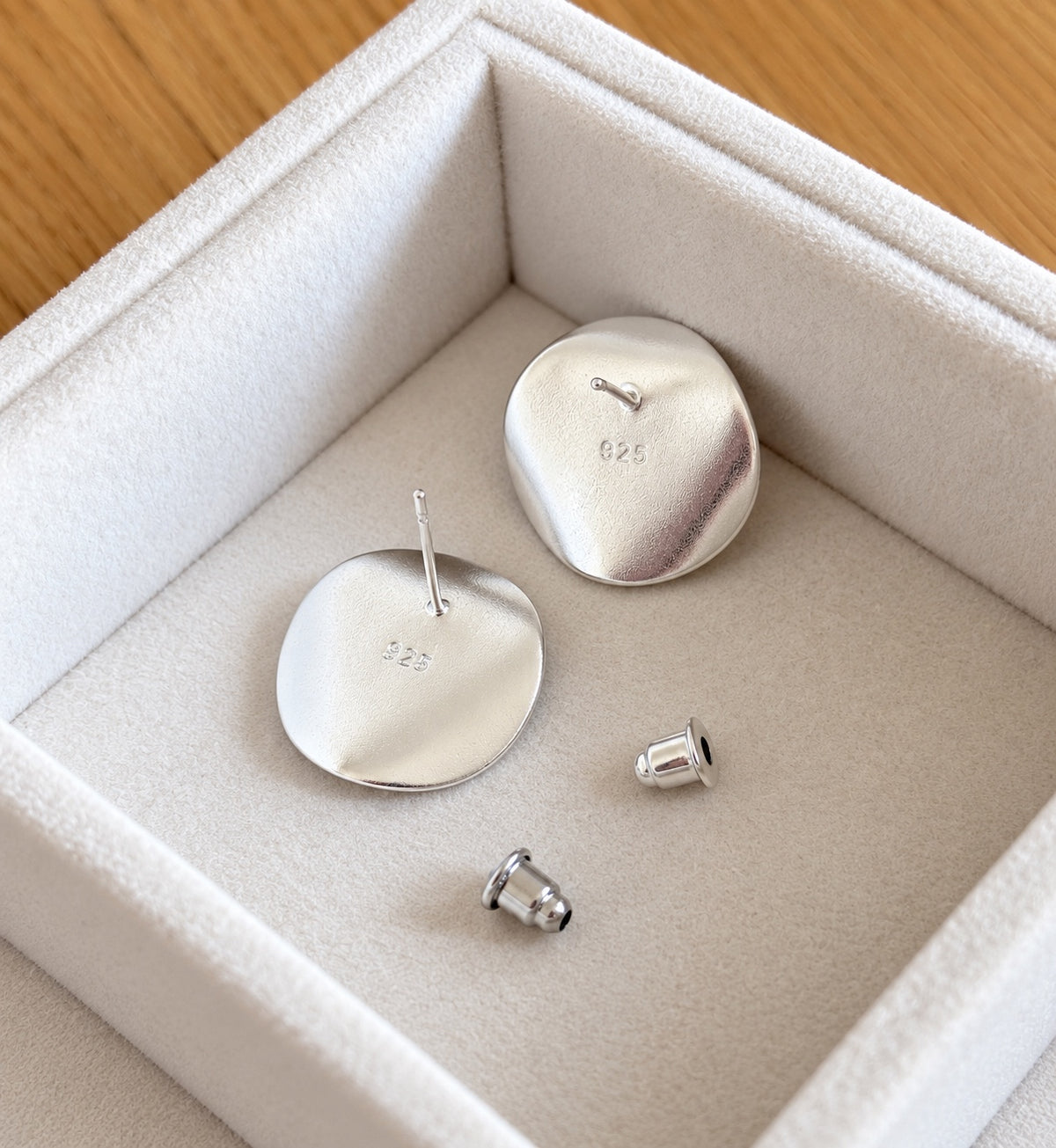 Back view of earrings showing 925 sterling silver hallmark-style stamp and backs