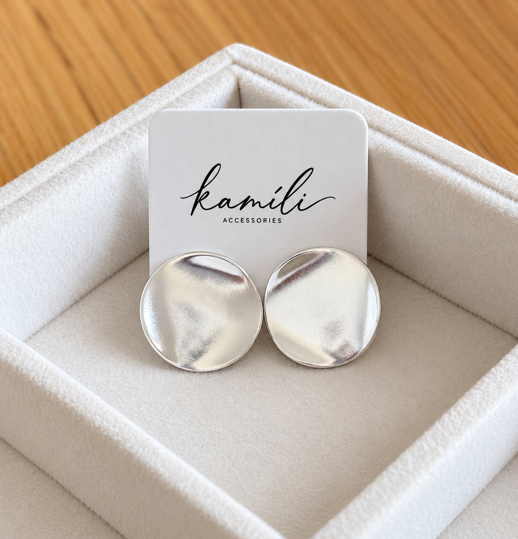 Organic disc studs displayed with Kamíli Accessories branded card
