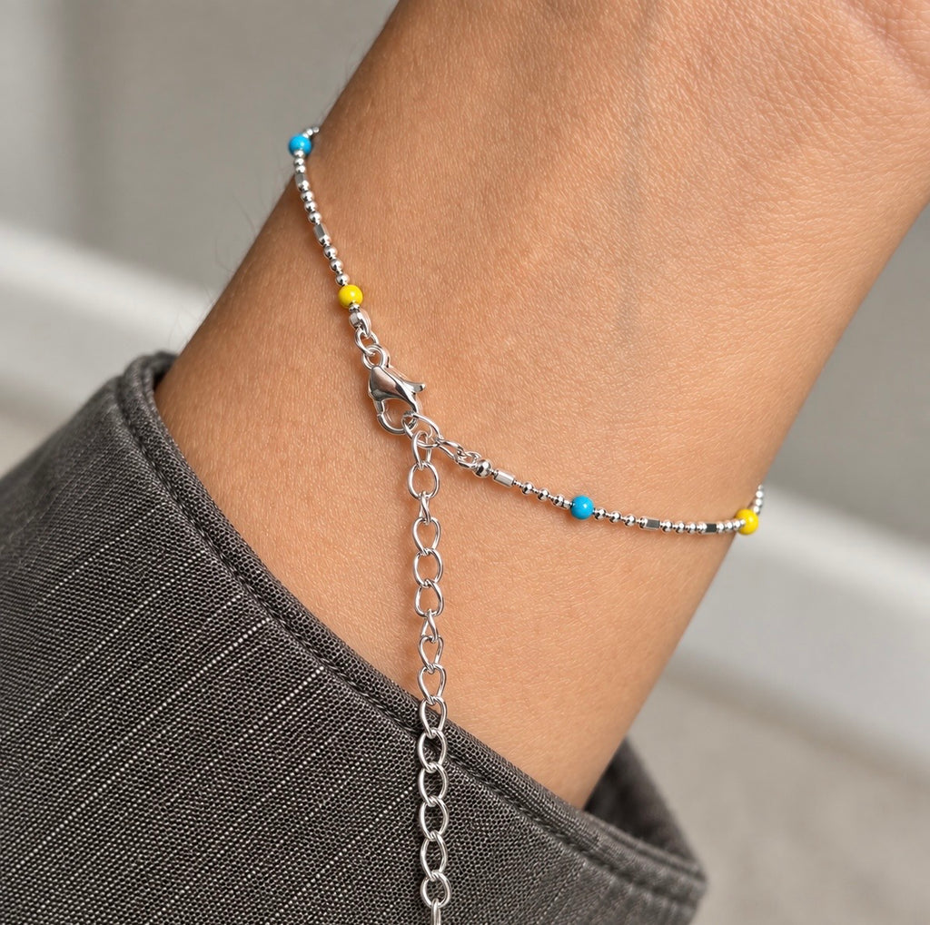 Silver rainbow bead bracelet showing the lobster clasp and extension chain