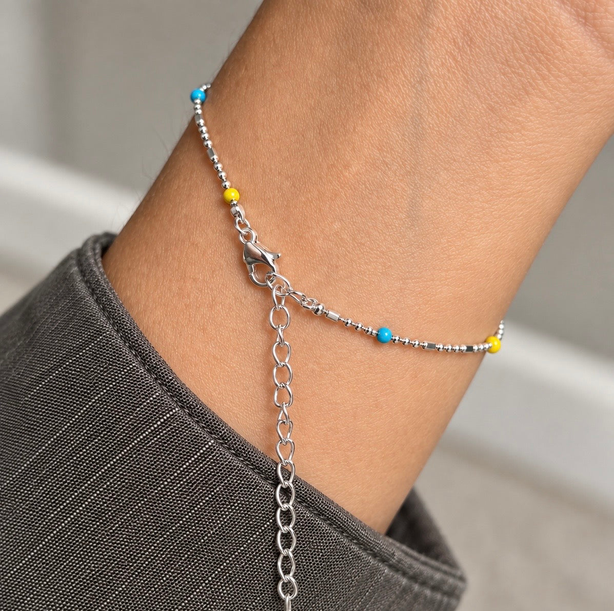 Silver rainbow bead bracelet showing the lobster clasp and extension chain