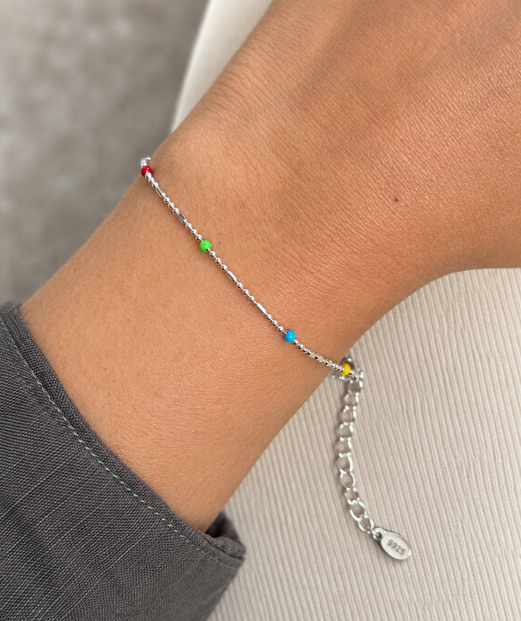 Close-up of rainbow bead bracelet worn on wrist