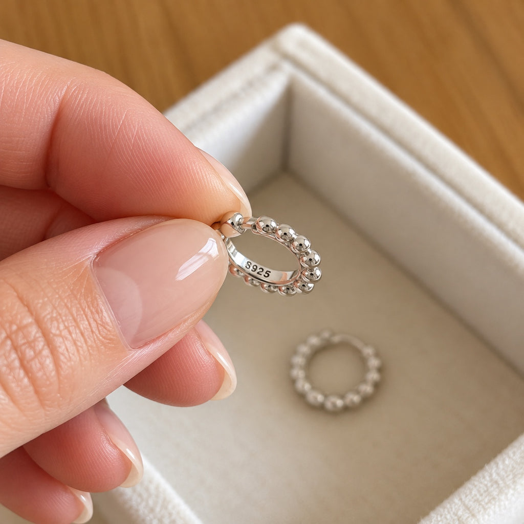 Close-up of S925 stamp inside silver beaded hoop earring
