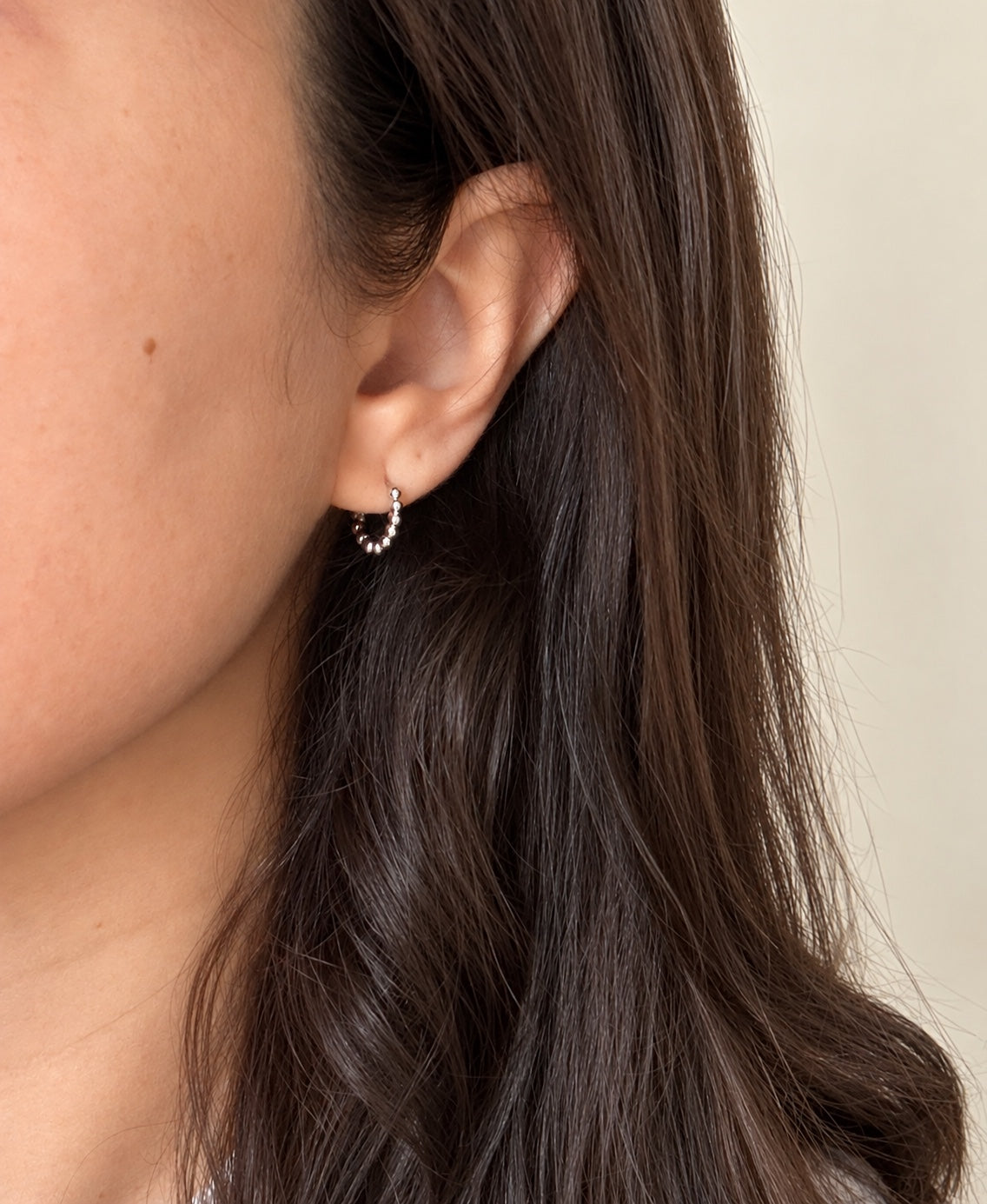 Small silver beaded 12mm huggie hoop worn on ear