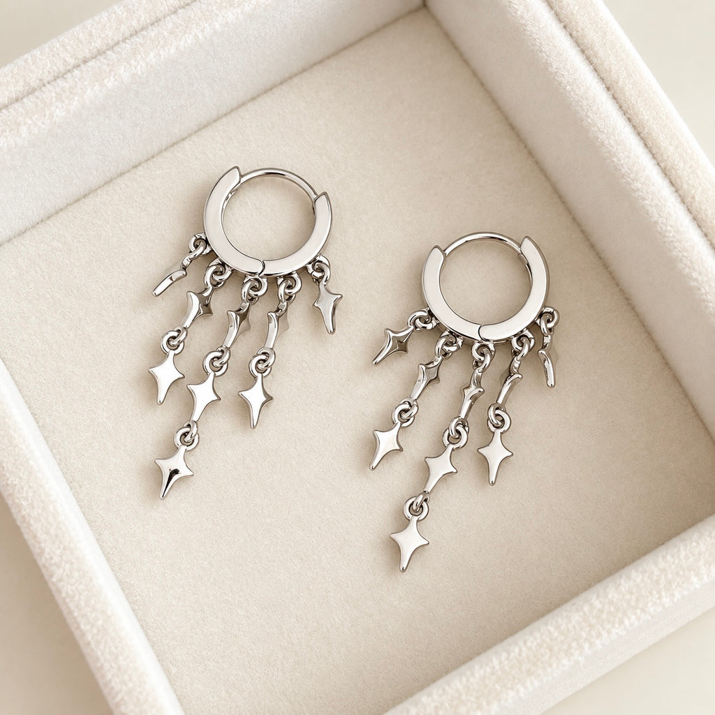 Star dangle hoops with multiple silver charms displayed at an angle