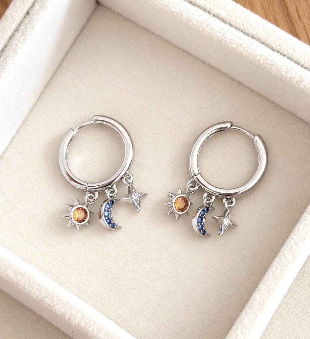 Sterling silver huggie hoop earrings with clear star, blue moon and golden sun CZ charms