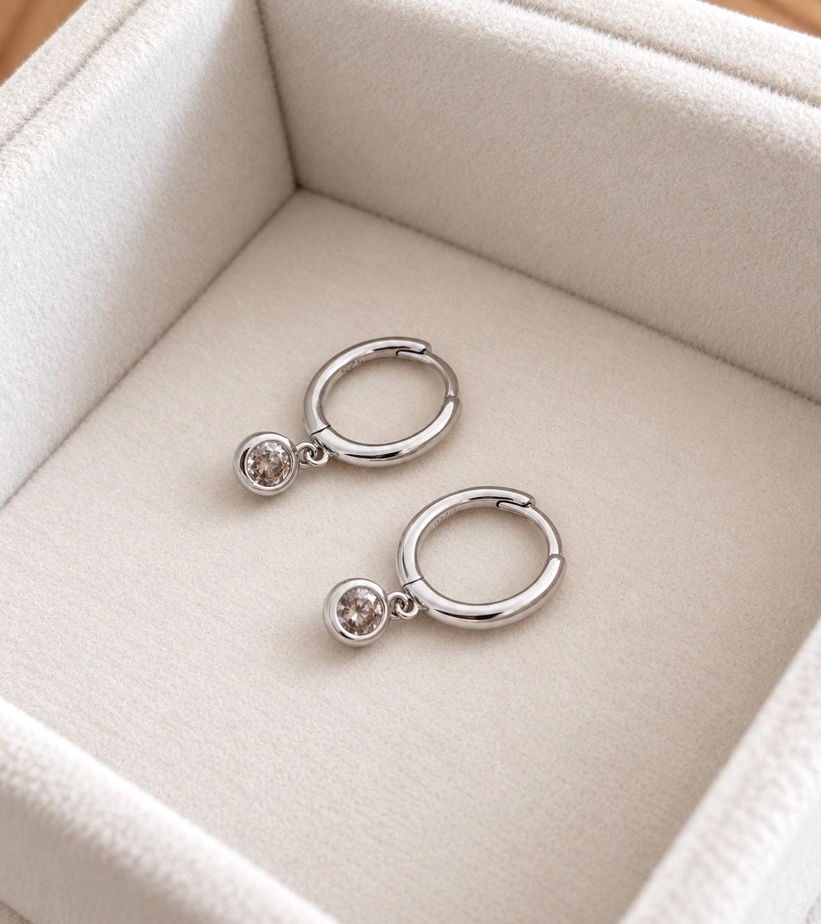 Silver colour hinged huggie hoop earrings with clear CZ stone dangles