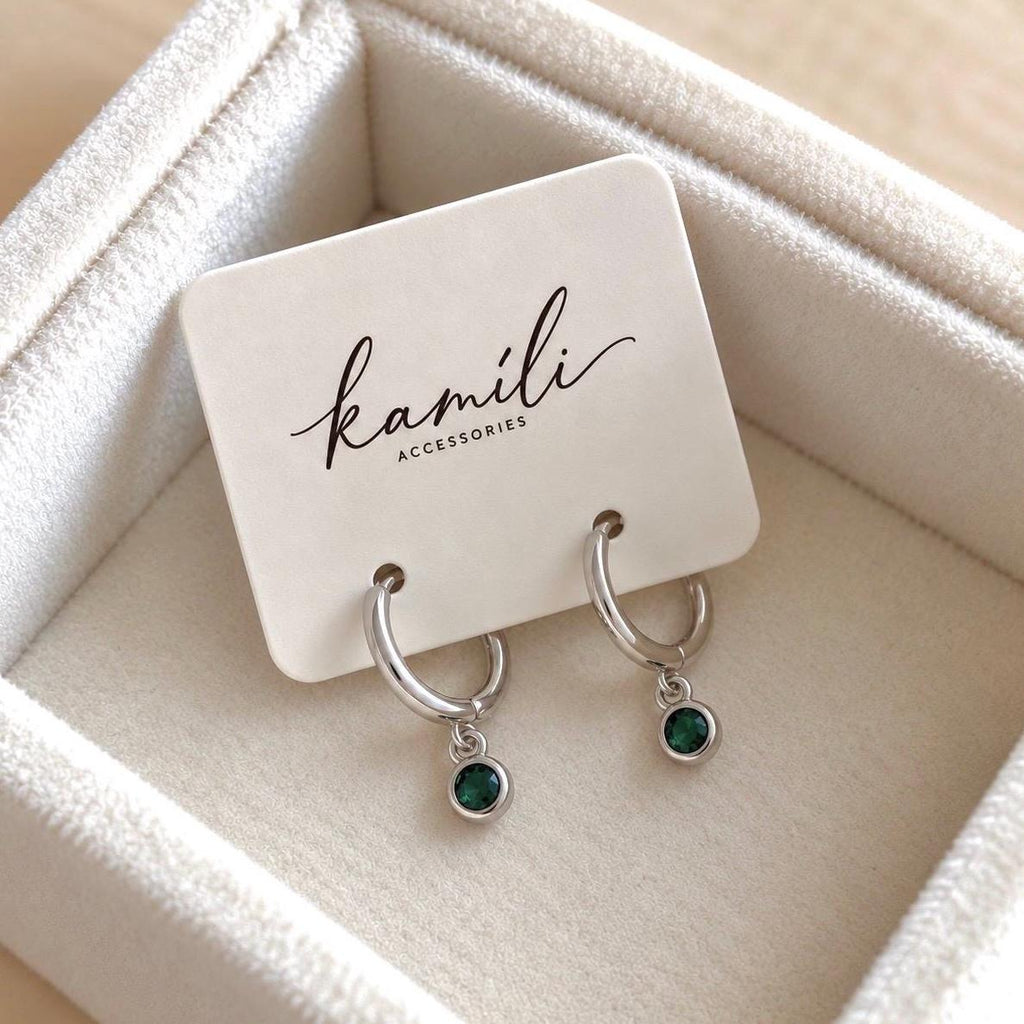 Silver colour green CZ drop huggie hoop earrings on Kamili Accessories card