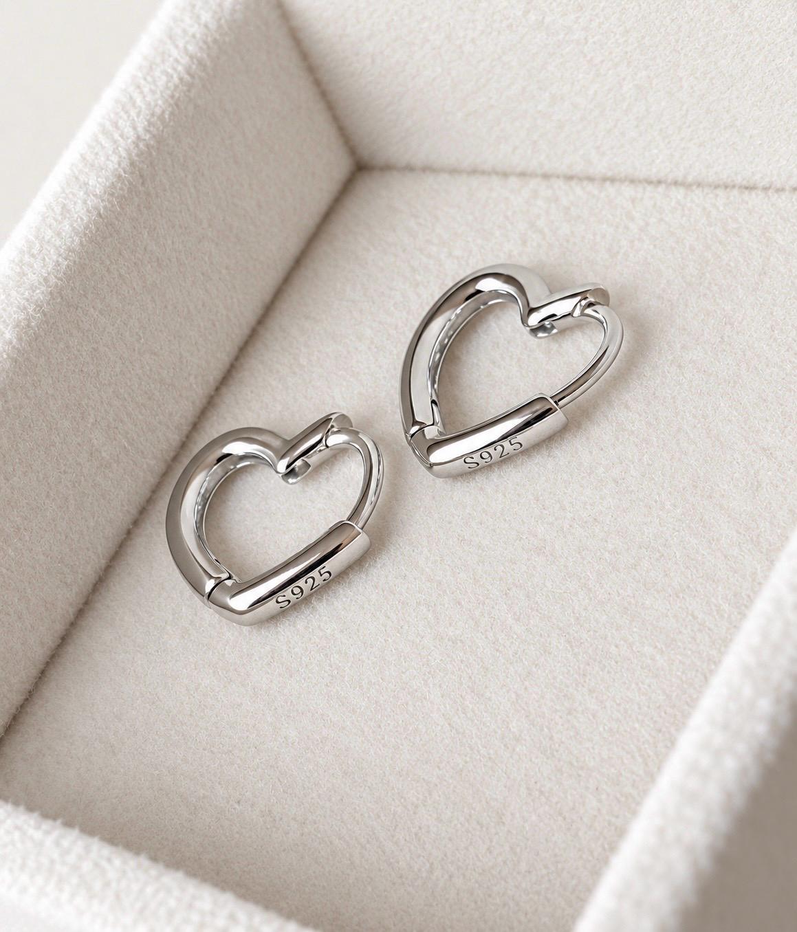 Reverse detail of silver heart hoops showing S925 sterling silver hallmark