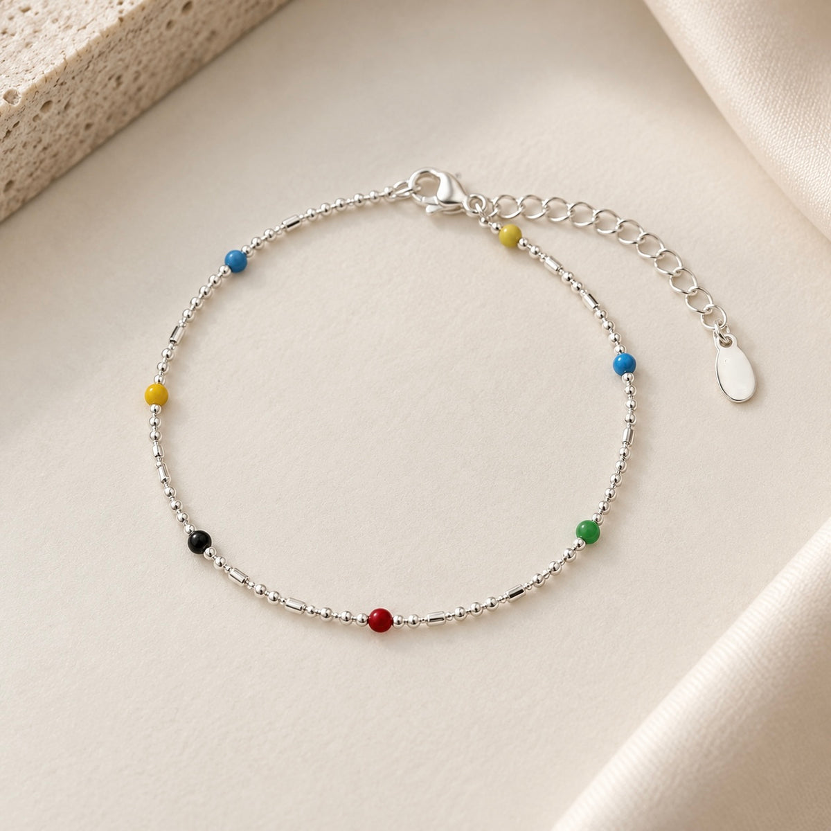 925 sterling silver rainbow bead bracelet with multicolour beads on ivory background