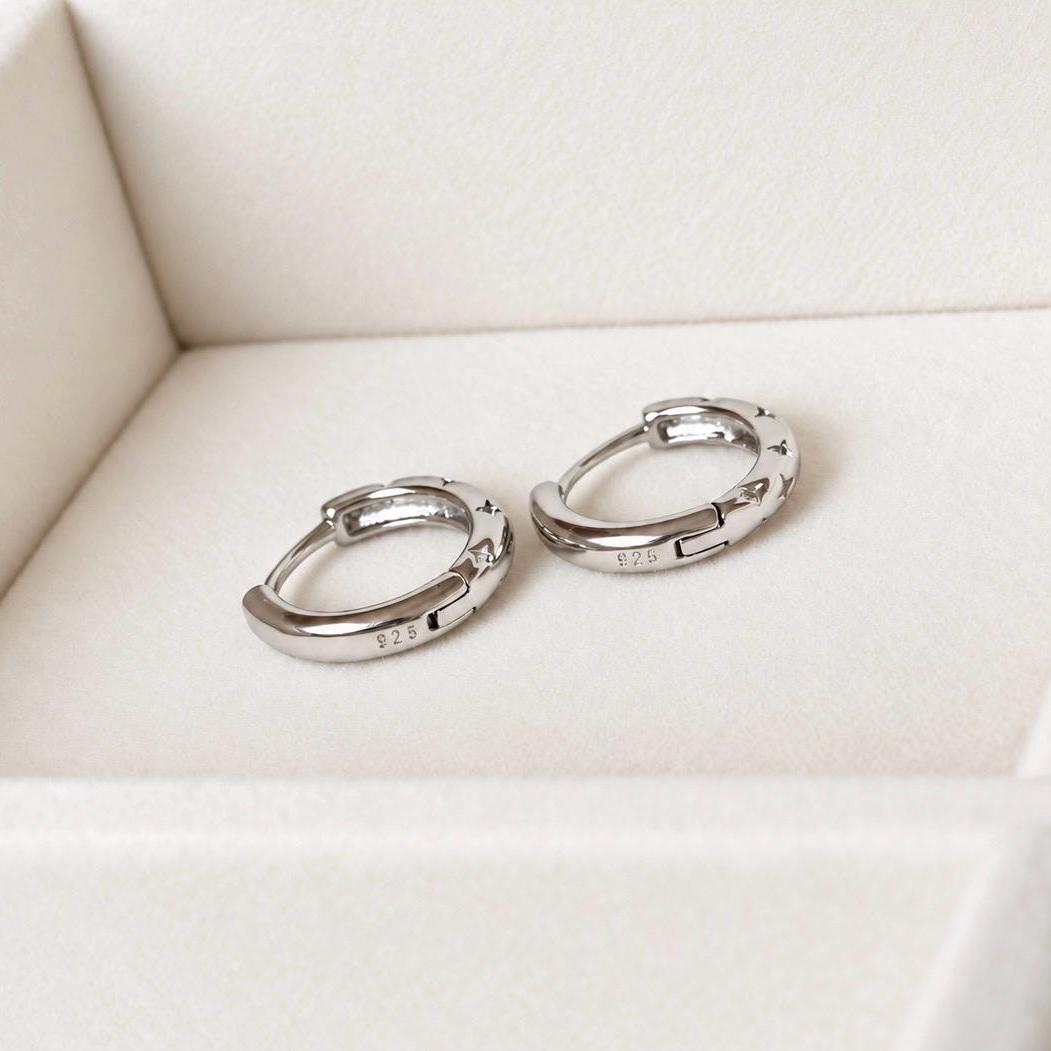 Back view of hinged 925 sterling silver star hoop earrings showing silver stamp