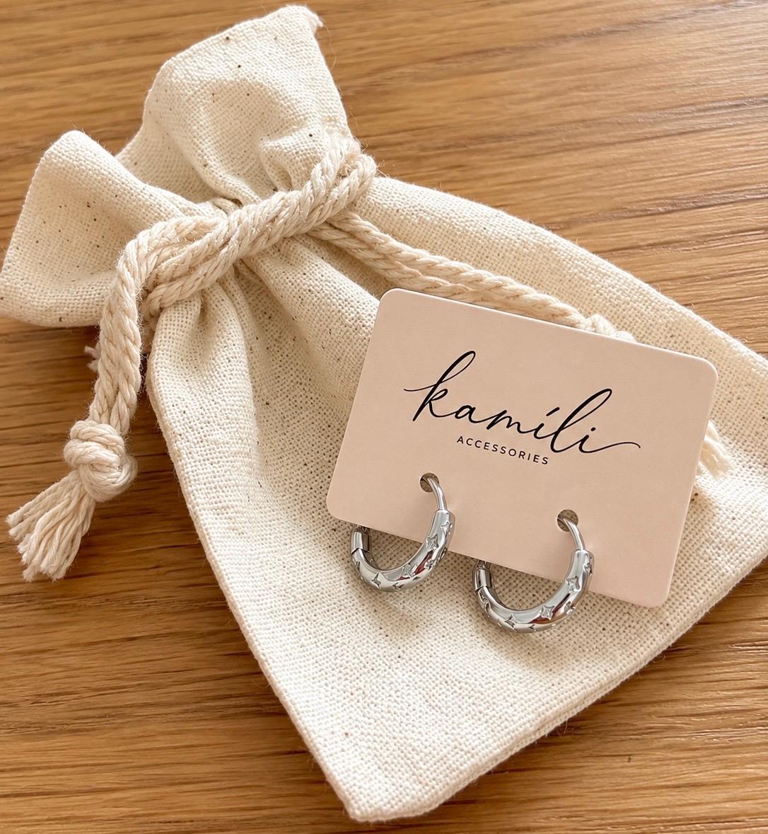 Silver celestial star hoop earrings on Kamili card with cotton gift pouch