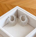 Front view of the silver sunburst hoop earrings in gift box
