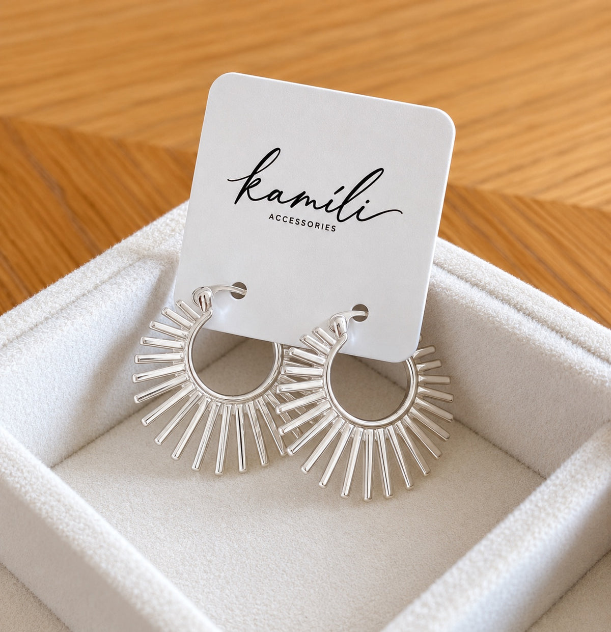 Sunburst earrings on Kamíli Accessories card angled view