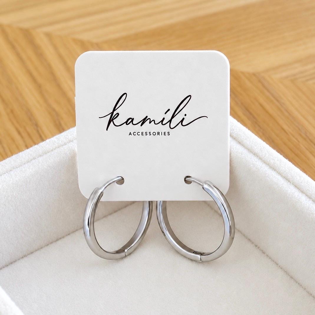 Polished sterling silver hoop earrings on Kamíli Accessories jewellery card