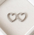 Pair of 925 sterling silver open heart hoop earrings on a cream jewellery display
