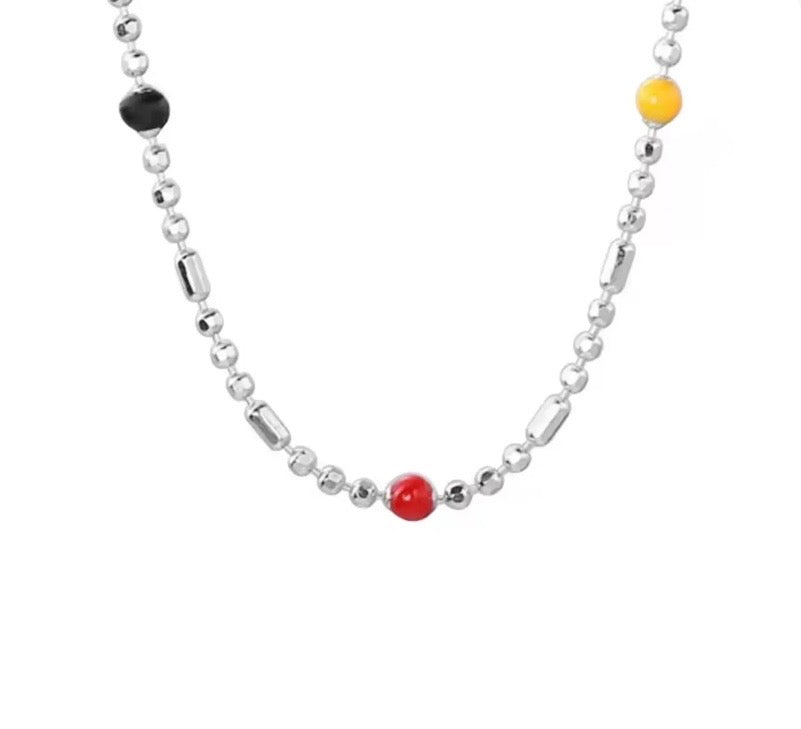 Close-up view of coloured beads and fine 925 sterling silver necklace chain