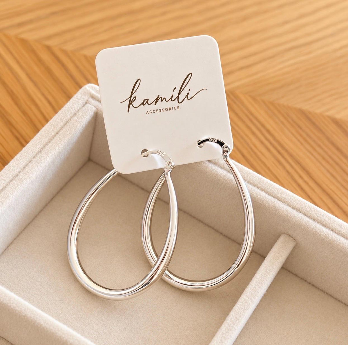 Kamíli Accessories teardrop hoop earrings displayed on branded jewellery card