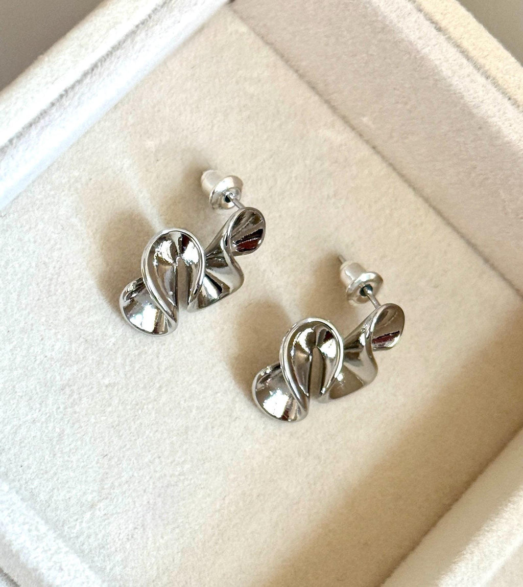 Back and side view of silver-colour abstract swirl stud earrings with butterfly backs