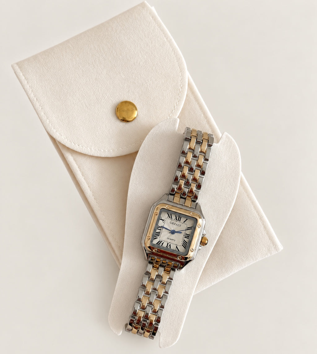 Two-tone rectangular quartz wristwatch displayed in its white presentation case